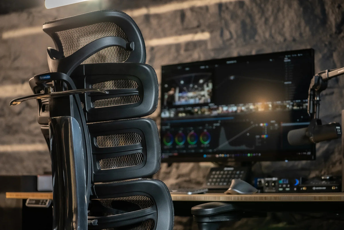 Rear three-quarter view of an OdinLake O2 chair at a media workstation