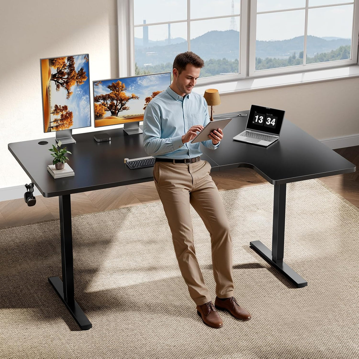 Black OdinLake L-shaped standing desk in a bright office with two work surfaces and open chair space