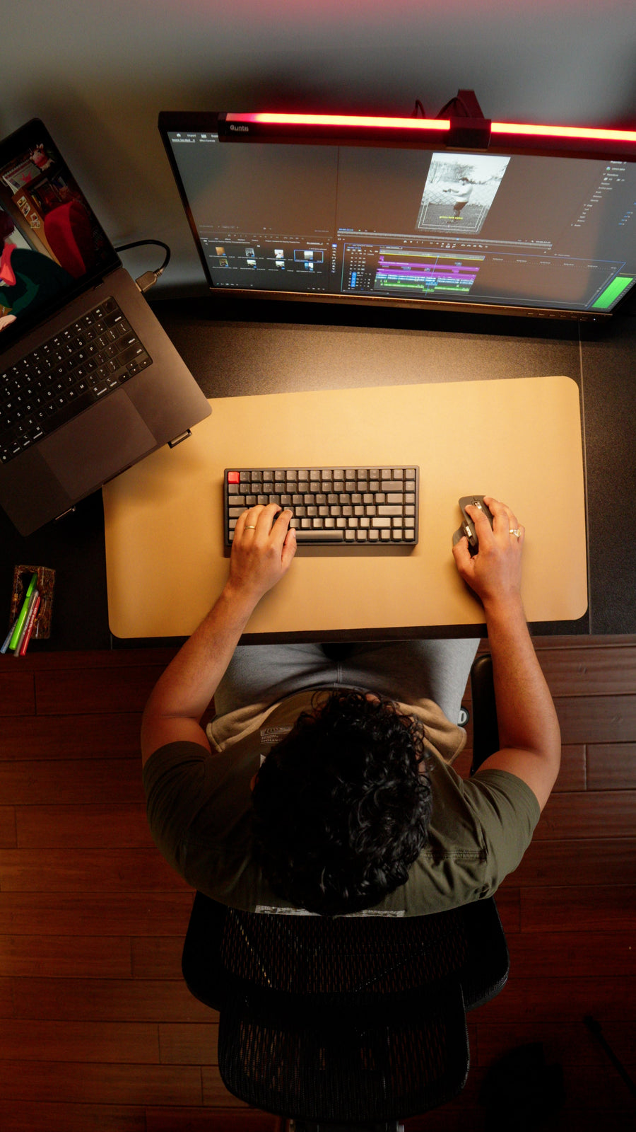 Overhead view of an OdinLake computer desk with monitor, laptop, keyboard, mouse, and active user
