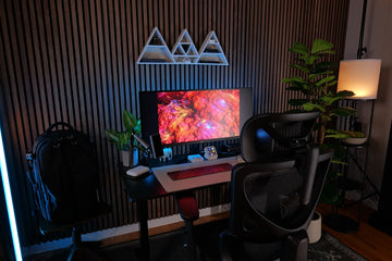 OdinLake chair in a dark home office with monitor, lighting and plants